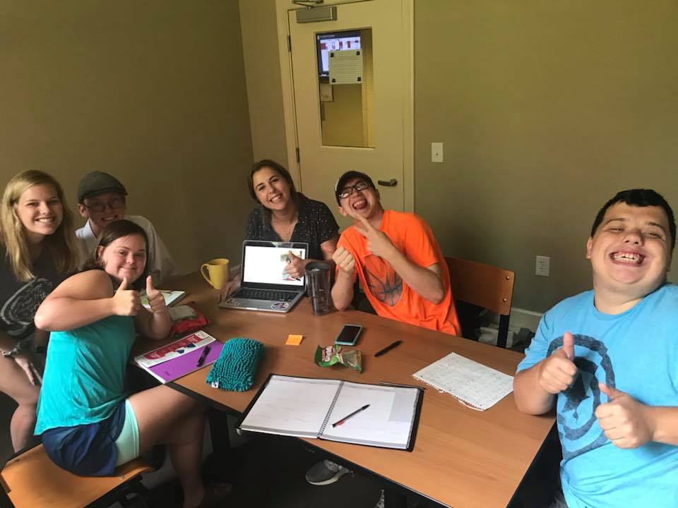 Group of people working at table together