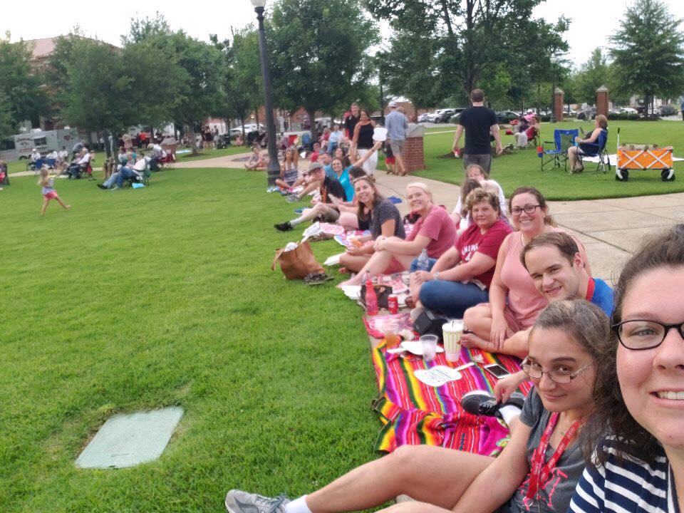 Group of people sitting in the grass