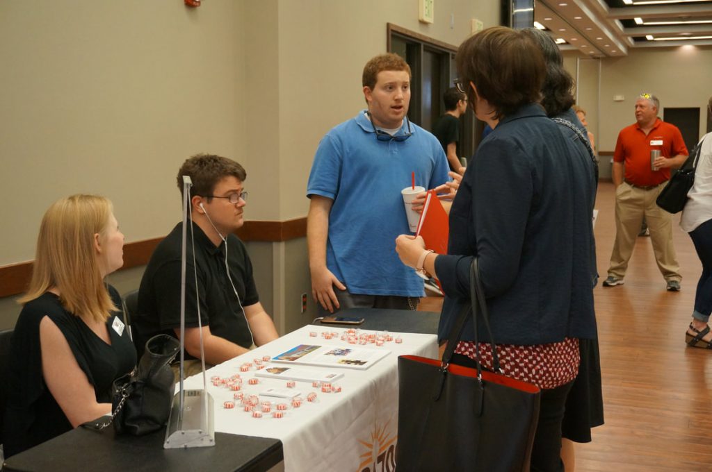 People talking around Horizons booth