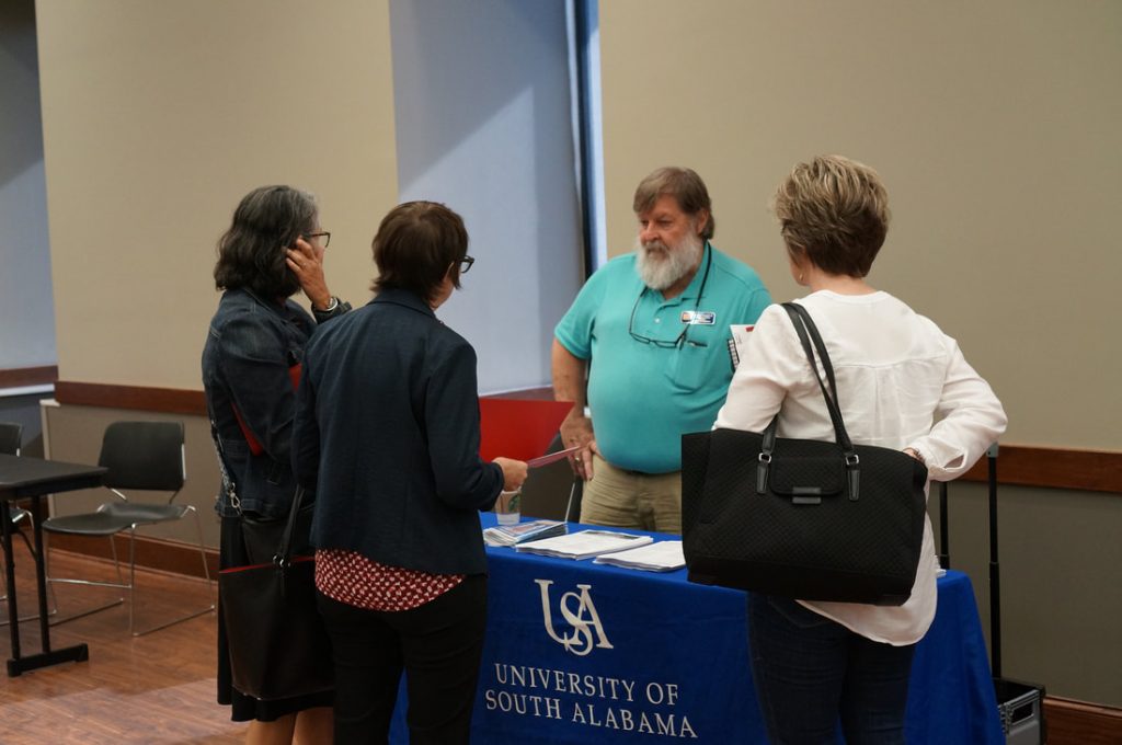 People talking around University of South Alabama booth