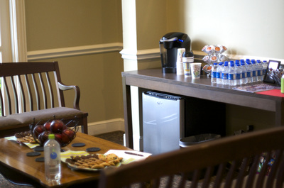 Table and chairs with waters and coffee machine in background