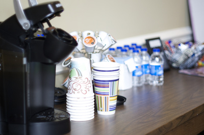 Coffee machine and waters on a table