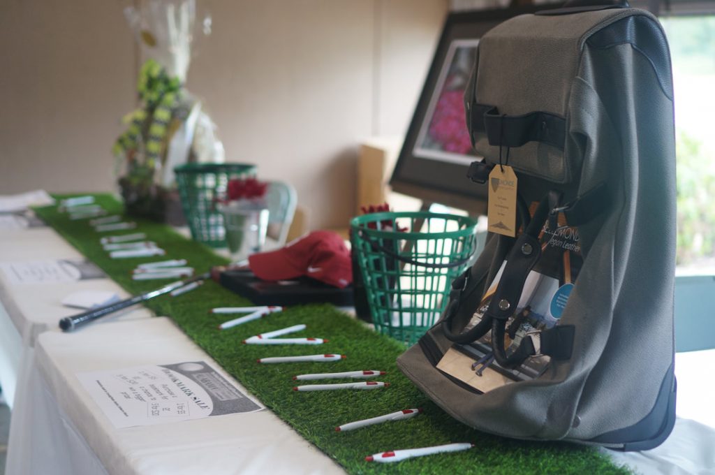 Golf green on table with various prizes