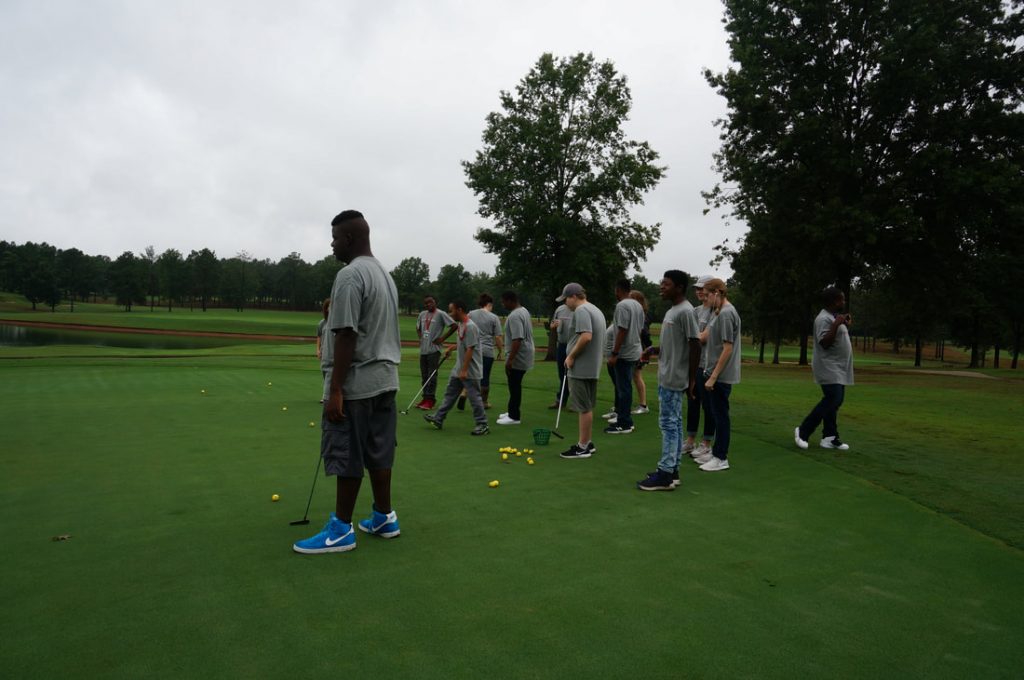 Group of people playing golf