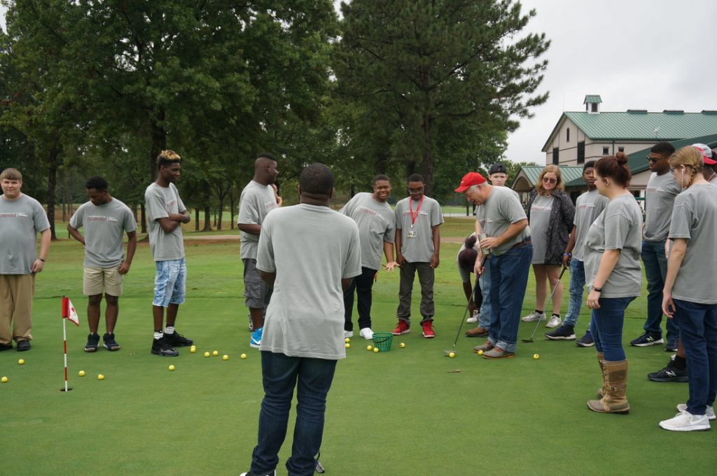 Group of people playing golf