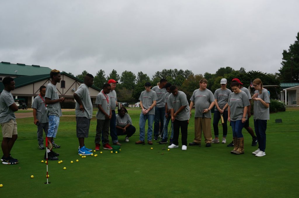 Group of people playing golf