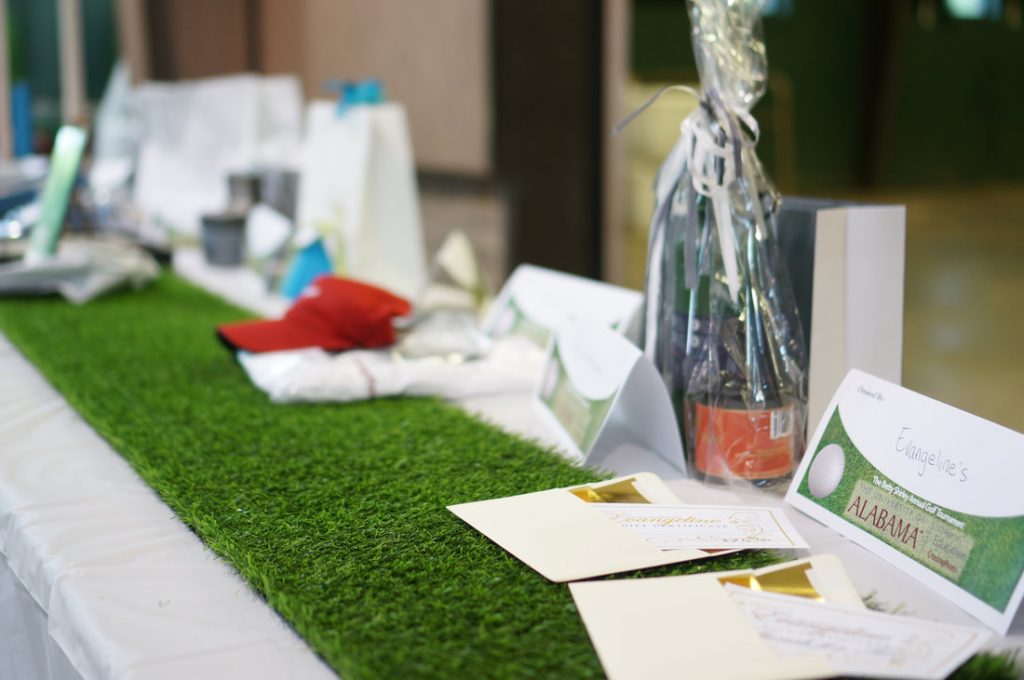 Golf green on table with various prizes