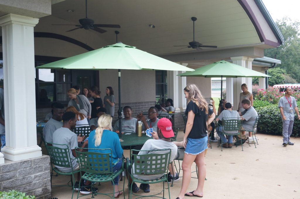 People sitting at outside tables