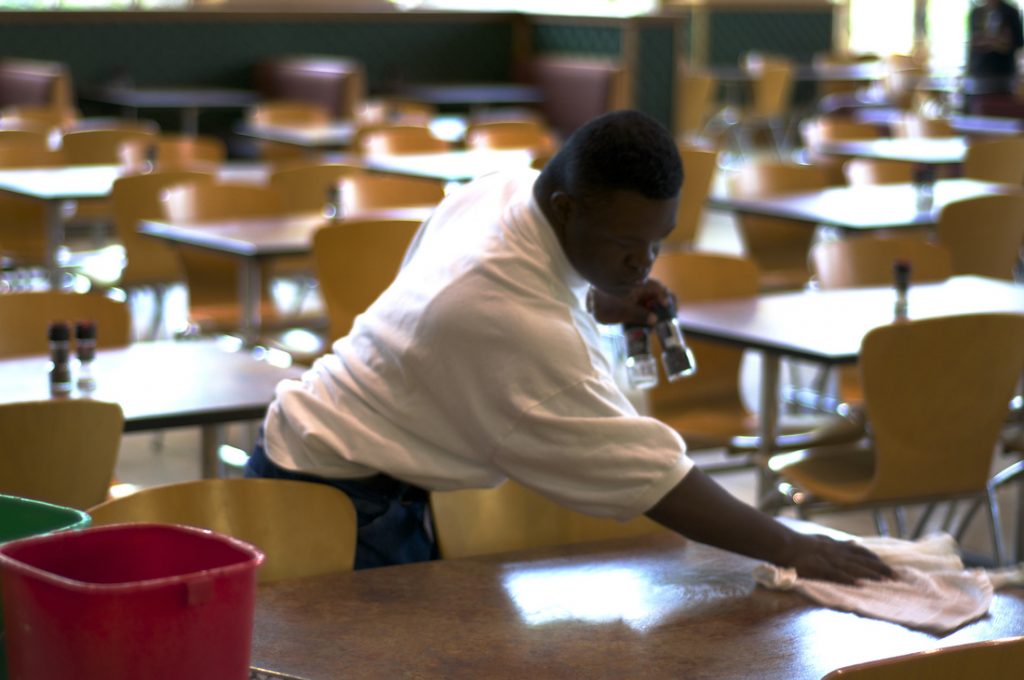 Man cleaning tables