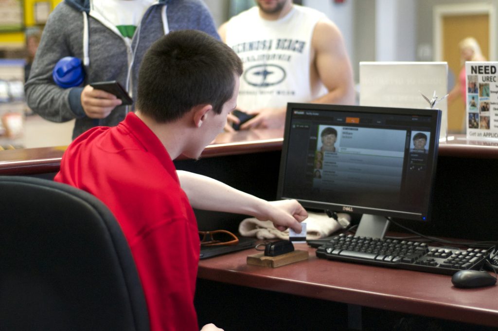 Man scanning id cards at desk