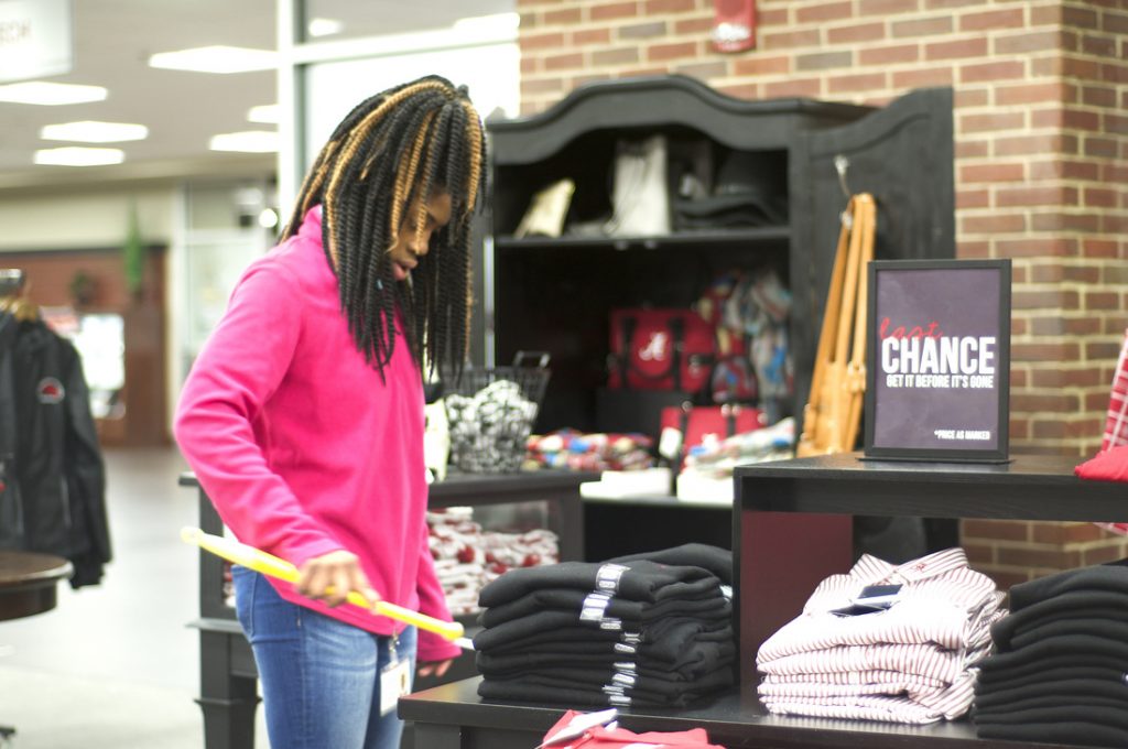 Girl organizing shirts at SupeStore